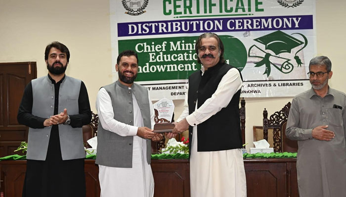 In this image, Chief Minister Ali Amin Gandapur distributes scholarship certificate to a student on May 22, 2024. — Facebook/Ali Amin Khan Gandapur