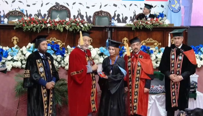 Higher Education Commission (HEC) Chairman Dr Mukhtar Ahmed awards gold medal to a student on May 22, 2024. — Screengrab via Facebook/NUML