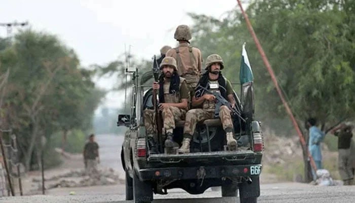 Security forces personnel ride on an army vehicle. —AFP/File