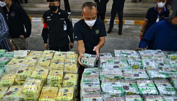 A policeman with confiscated drugs in Myanmar.— AFP/file