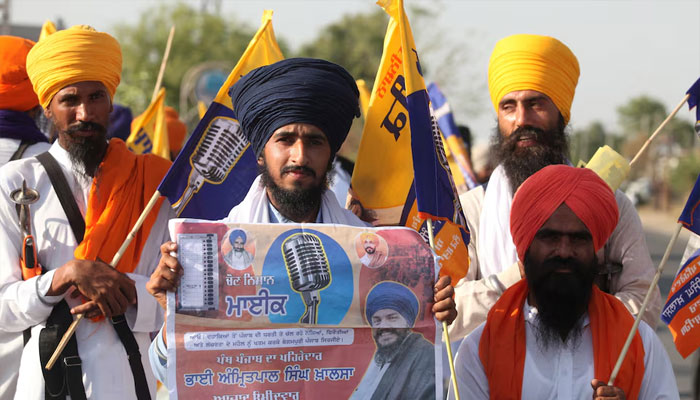 A supporter of Sikh separatist leader Amritpal Singh, an independent candidate from Khadoor Sahib constituency, holds an election campaign poster of Amritpal, in Tarn Taran district, Punjab, India, May 28, 2024. — Reuters