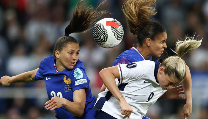 France’s defenders Eve Perisset (L) and Maelle Lakkar (rear R) fight for the ball against England’s striker Alessia Russo (front R). — AFP File