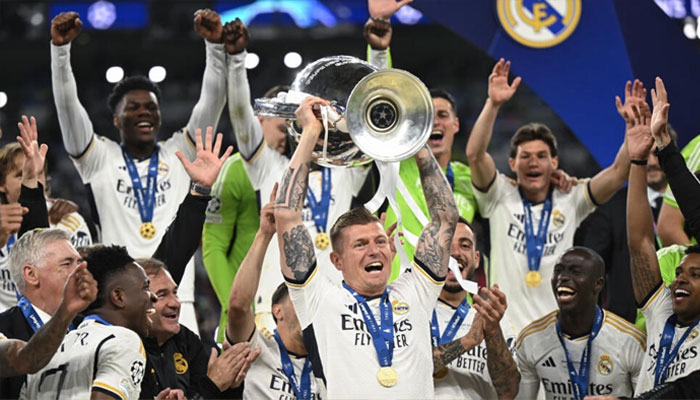 Toni Kroos (centre) seen lifitng Champions League trphy after the final game of his club career on May 2, 2024. — AFP/file