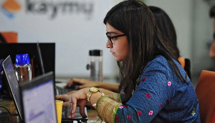 A representational image of a female employee working in an office in Karachi. — AFP/File