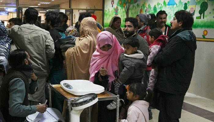 A representational image showing parents pictured alongside their children at the Children’s Hospital in Lahore. — AFP/File