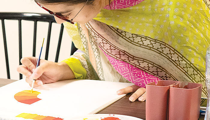 Representational image showing a woman engaged in painting activity. — The News/File