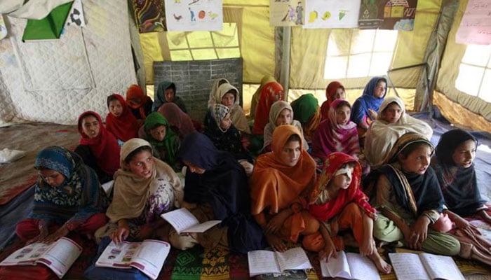 Internally displaced girls attend a class inside a tent at an UNHCR camp (United Nations High Commission for Refugees) in the outskirts of Peshawar, KP. — Reuters/File