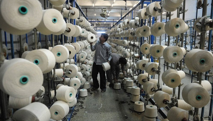 Workers can be seen in a textile factory in Pakistan. — AFP/File