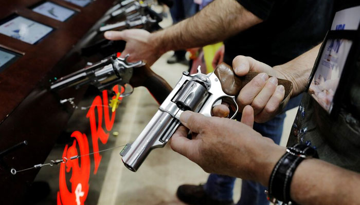 A man handles a revolver during the National Rifle Association annual meeting in Indianapolis, Indiana, US on April 27, 2019. — Reuters