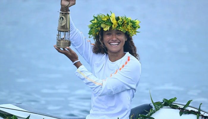 French surfer Vahine Fierro holds the Olympic flame during the Olympic torch relay in Teahupo’o in Tahiti — AFP/file