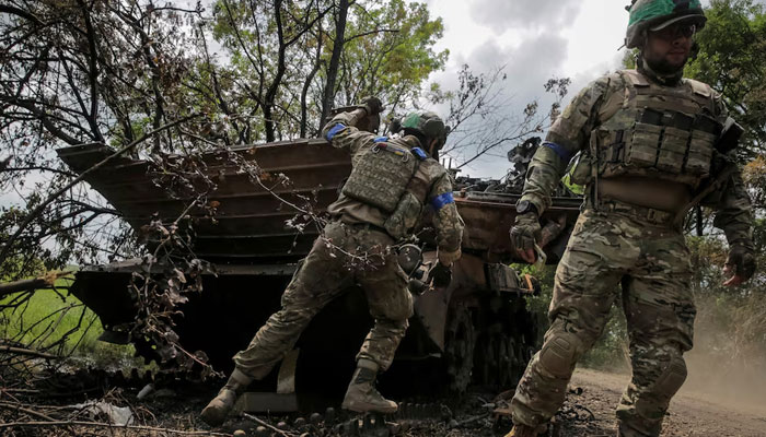 Ukrainian service members check a destroyed Russian a BMP-2 infantry fighting vehicle near the front line in the newly liberated village Storozheve in Donetsk region, Ukraine June 14, 2023. — Reuters