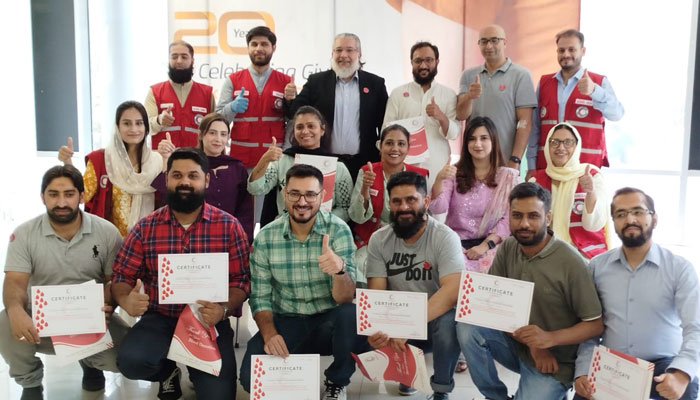 Participants pose for a group photo with certificates during the 20th anniversary of World Blood Donor Day on June 14, 2024. — Facebook/Pakistan Red Crescent