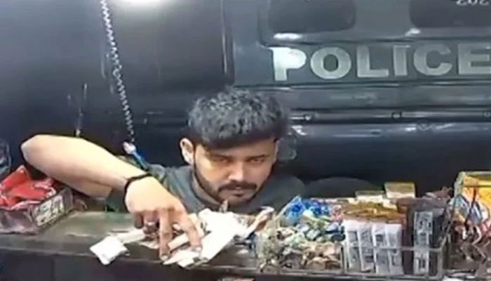 An image showing a person robbing a betel shop in Karachis Gulshan-e-Iqbal area o June 12, 2024. — Screengrab via Geo News