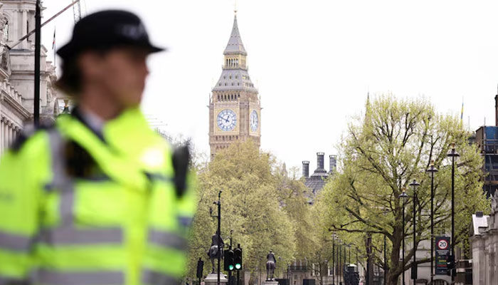 A  UK police official stands guard near Downing Street, in London, UK. — Reuters/File