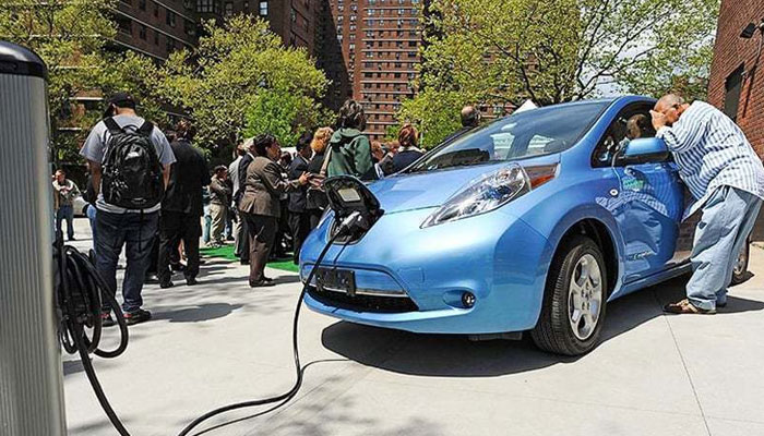 An electric car is being recharged at a charging station. — AFP File