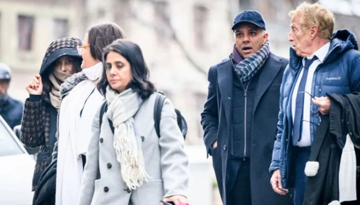 Billionaire family members Namrata Hinduja (left) and Ajay Hinduja (second from right) arrive at the Geneva’s courthouse with their lawyers. — AFP