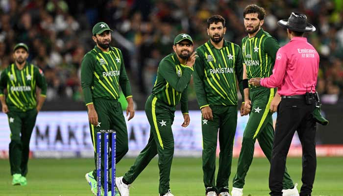 Pakistans captain Babar Azam (centre) listens to Sri Lankas umpire Kumar Dharmasena during the ICC mens T20 World Cup 2022 final cricket match England and Pakistan in Melbourne on November 13, 2022. — AFP