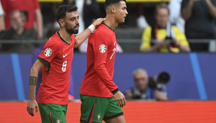 Bruno Fernandes and Cristiano Ronaldo celebrate together after the duo combined for Portugals third goal in their 3-0 win over Turkey at Euro 2024. — AFP