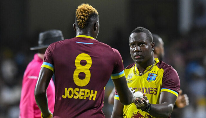 West Indies’ captain Rovman Powell (R) gives the ball to West Indies’ Alzarri Joseph (L) during the ICC men’s Twenty20 World Cup 2024 Super Eight cricket match. — AFP