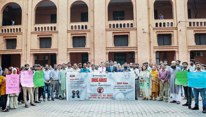 Participants pose for a group photo with banners at a walk to mark the International Day against Drug Abuse & Illicit Trafficking’ with the theme ‘Choose Life, Not Drug, Together, We Can End This’ on June 26, 2024. — Facebook/UVAS