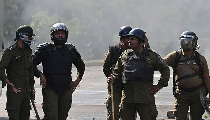 Policemen stand guard after a protest in Lahore on May 11, 2023. — AFP