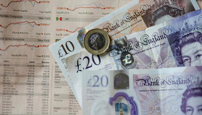 Sterling pound banknotes and coins displayed on a table in London, UK, April 22, 2022. — AFP