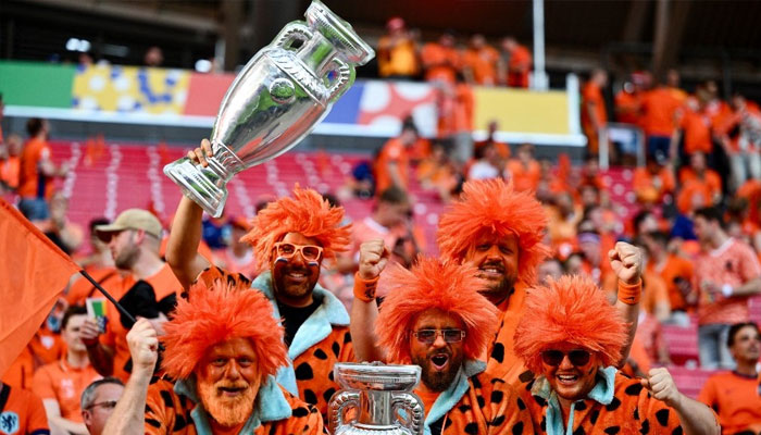 Nederlandse fans met nepbekers juichen voor de Euro 2024 Groep D-voetbalwedstrijd tussen Nederland en Frankrijk in het Leipzig Stadion in Leipzig op 21 juni 2024. - AFP
