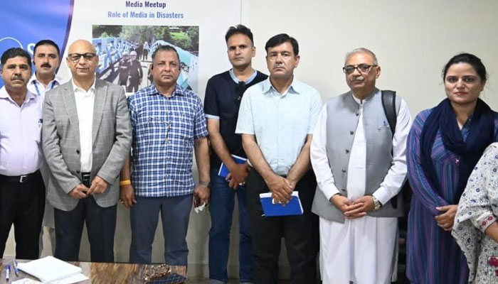 Participants pose for a group photo during an event. — APP/File