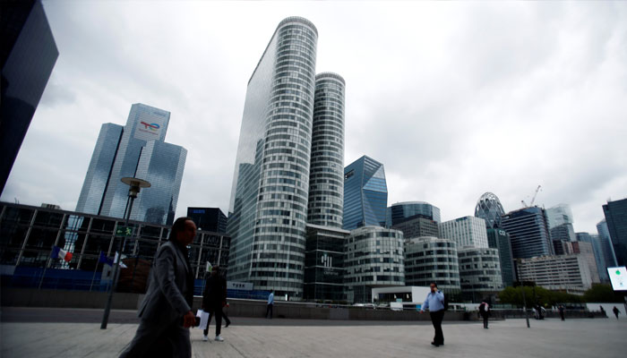 People walk through the financial and business district of La Defense in Puteaux near Paris, France, August 23, 2021. — Reuters