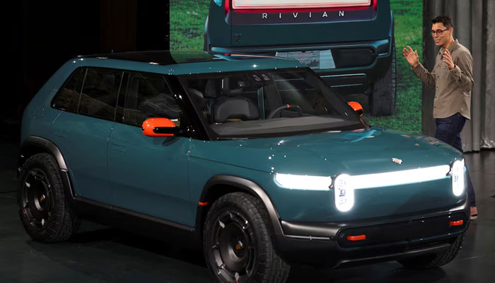 Rivian CEO RJ Scaringe speaks next to a R3X SUV, during an event to unveil R2 SUV in Laguna Beach, California, US, March 7, 2024. — Reuters