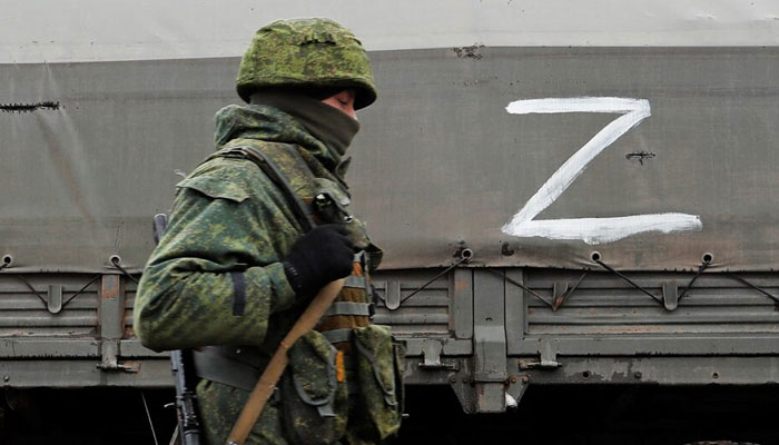 A serviceman of pro-Russian militia walks nest to a military convoy of armed forces of the separatist self-proclaimed Luhansk Peoples Republic (LNR) on a road in the Luhansk region, Ukraine February 27,2022. — Reuters