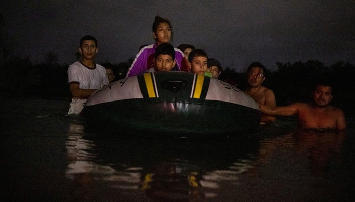 Mexicans pull a raft full of asylum-seeking unaccompanied minors from Central and South America across the Rio Grande river into the United States from Mexico in Roma, Texas, US, May 13, 2022. — Reuters