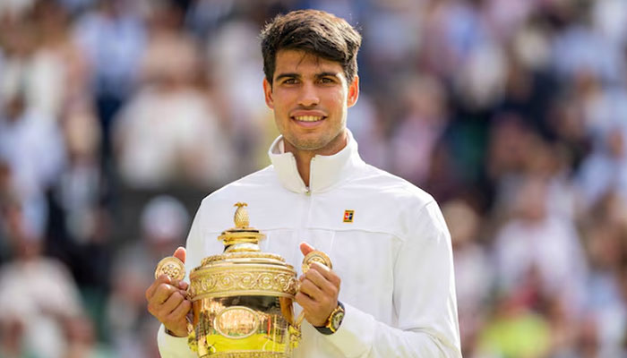 Carlos Alcaraz of Spain poses with the trophy after winning the menss singles Wimbledeon final against Novak Djokovic of Serbia at All England Lawn Tennis and Croquet Club, UK on Jul 14, 2024. — Reuters