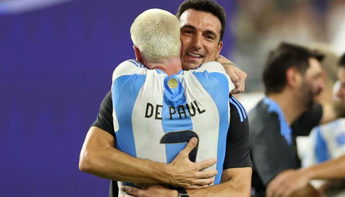 Argentina coach Lionel Scaloni embraces midfielder Rodrigo De Paul after Sundays Copa America triumph. — AFP/file