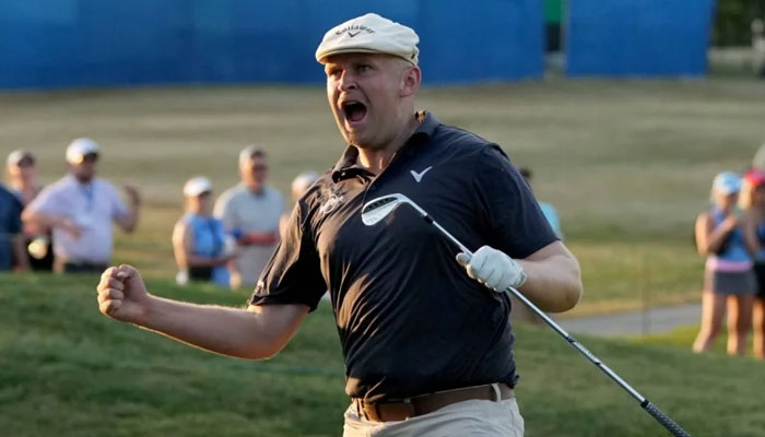 Harry Hall of England reacts after chipping in for a birdle on the ninth green during the third playoff hole during the final round of the kentucky championship at Knee Trace golf club on July 14, 2024. — AFP
