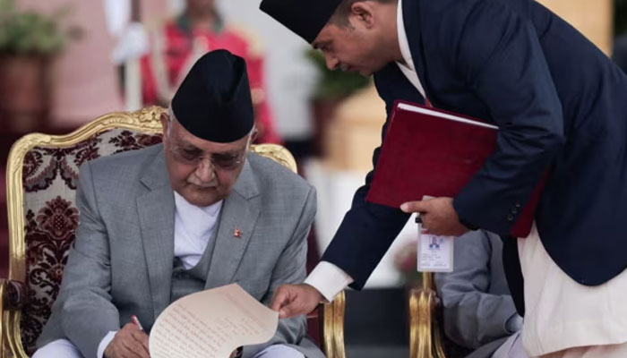 Newly appointed Prime Minister KP Sharma Oli signs a document after taking the oath of office at the presidential building Shital Niwas in Kathmandu, Nepal, July 15, 2024. — Reuters