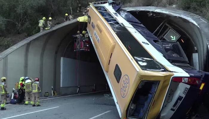 Rescue workers pictured alongside the bus that was involved in a crash near Barcelona. — Catalan Firefighters/File