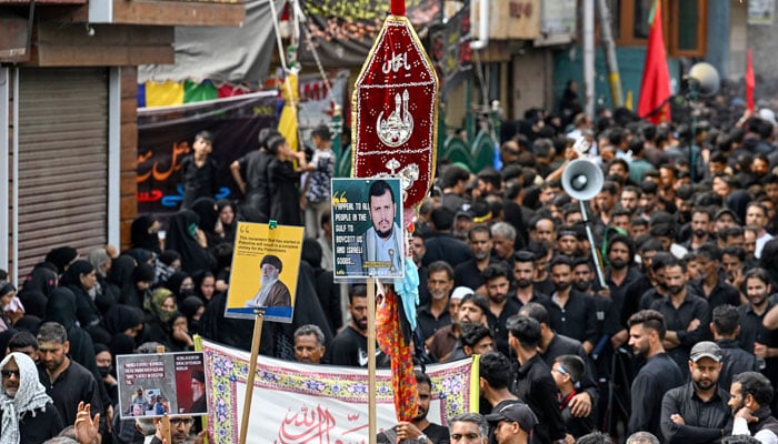 Kashmiri mourners take part in a religious procession on the tenth day of Ashura in the Islamic month of Muharram in Srinagar on July 17, 2024. — AFP
