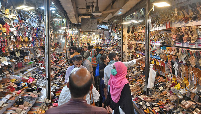 A representational image showing people busy in shopping activities at a market in Lahore. — AFP/file