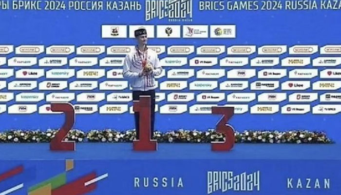 An athlete is standing at the victory stand during the 2024 BRICS Games in Kazan, Russia. —X/@ianbremmer/File