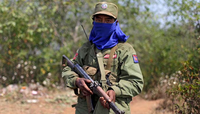 A rebel soldier of the Myanmar National Democratic Alliance Army (MNDAA) holds his rifle as he guards near a military base in Kokang region March 11, 2015. — Reuters