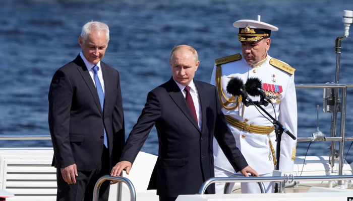 Russias President Vladimir Putin (centre), Defense Minister Andrei Belousov (left) and Russian Navy Commander-in-Chief Admiral Alexander Moiseyev (right) attend the annual Navy Day parade in Saint Petersburg, July 28, 2024. — Reuters