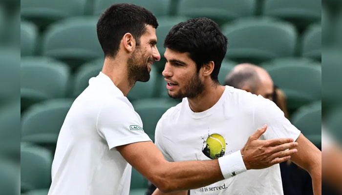 Serbias Novak Djokovic (left) greets Spains Carlos Alcaraz at a Wimbledon practice session — AFP/File