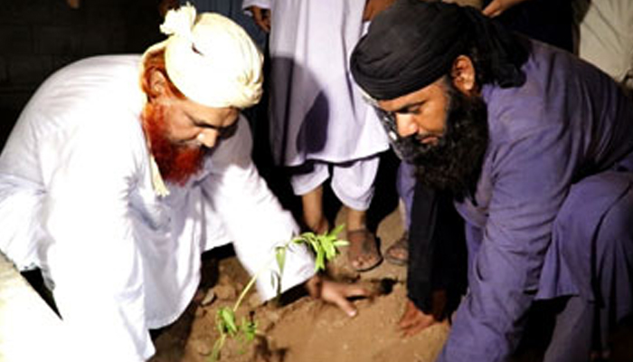 Member Shura Dawat-e-Islami Haji Yafoor Raza Attari is planting saplings. — Dawat-e-Islami/Website/File