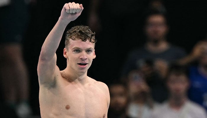 Frances Leon Marchand celebrates after winning gold in the final of the mens 200m breaststroke swimming event during the Paris 2024 Olympic Games in Nanterre, west of Pari on July 31, 2024. — AFP