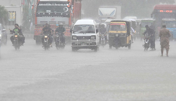 Commuters travel during heavy rain in Karachi on July 30, 2024. — INP