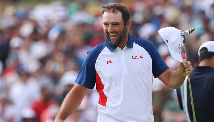 US Scottie Scheffler celebrates after completing the course in round 4 of the mens golf individual stroke play of the Paris 2024 Olympic Games in Paris on August 4, 2024. — AFP
