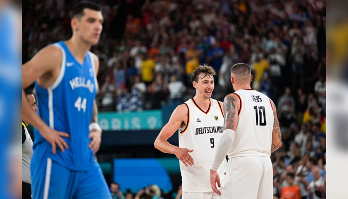 Germanys #09 Franz Wagner celebrates with Germanys #10 Daniel Theis after Germany won the mens quarterfinal basketball match between Germany and Greece during the Paris 2024 Olympic Games in Paris on August 6, 2024. — AFP