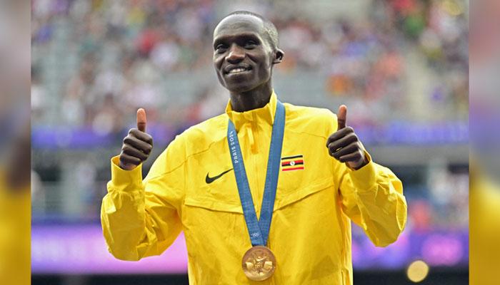 Gold medallist Ugandas Joshua Cheptegei poses on the podium during the medal ceremony for the mens 10000m final of the athletics event at the Paris 2024 Olympic Games in Paris on August 3, 2024. — AFP
