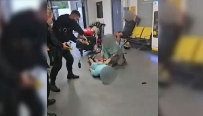 In this undated picture, a police officer is subjecting a man to torture at the Manchester Airport. — BBC/Screengrab